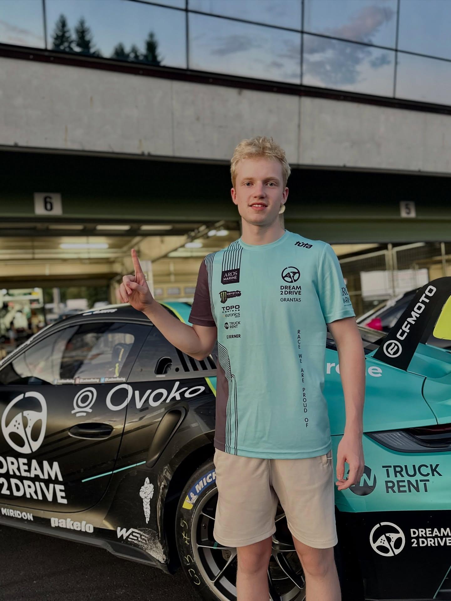 Dream 2 Drive esport champion next to the race car