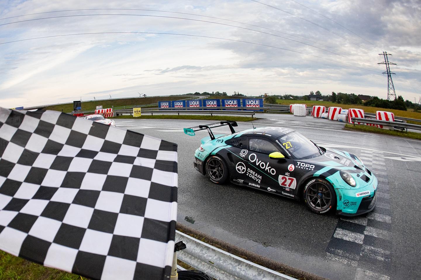 Dream 2 Drive Porsche GT3 crossing the finish line under the checkered flag